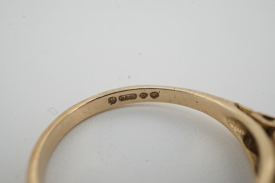 A 1960's 9ct gold ruby and diamond cluster set half hoop ring, size P, gross weight 3.1 grams.